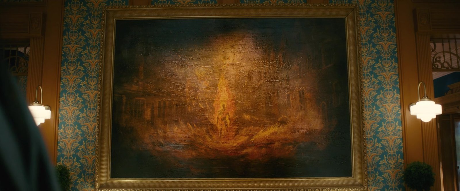 A framed oil painting of a figure engulfed in flames hanging on a patterned wall